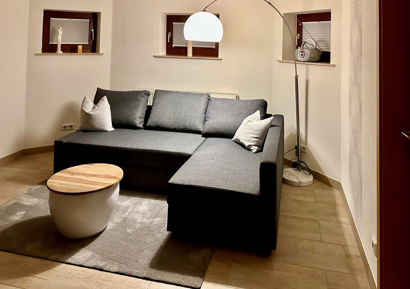 Wohnbereich mit Sofa, Couchtisch und Stehlampe